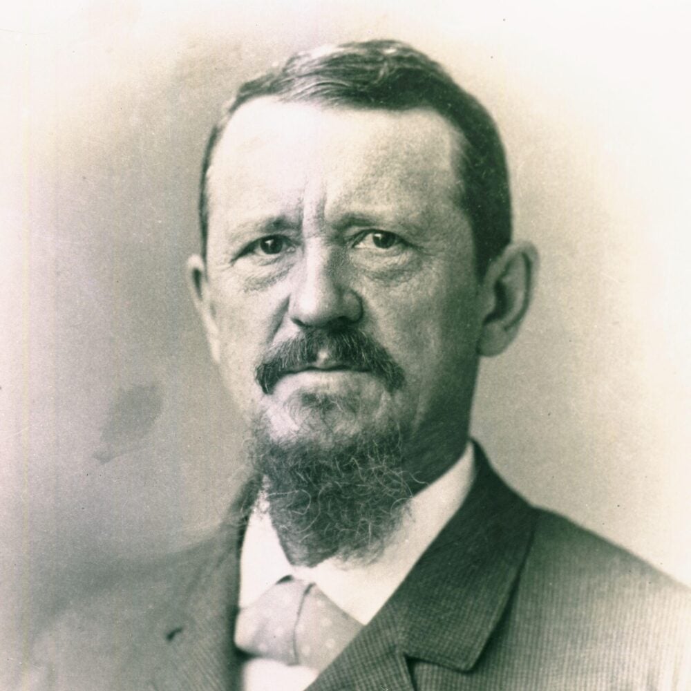 A monochrome portrait of Wharton School founder Joseph Wharton with a proud look.